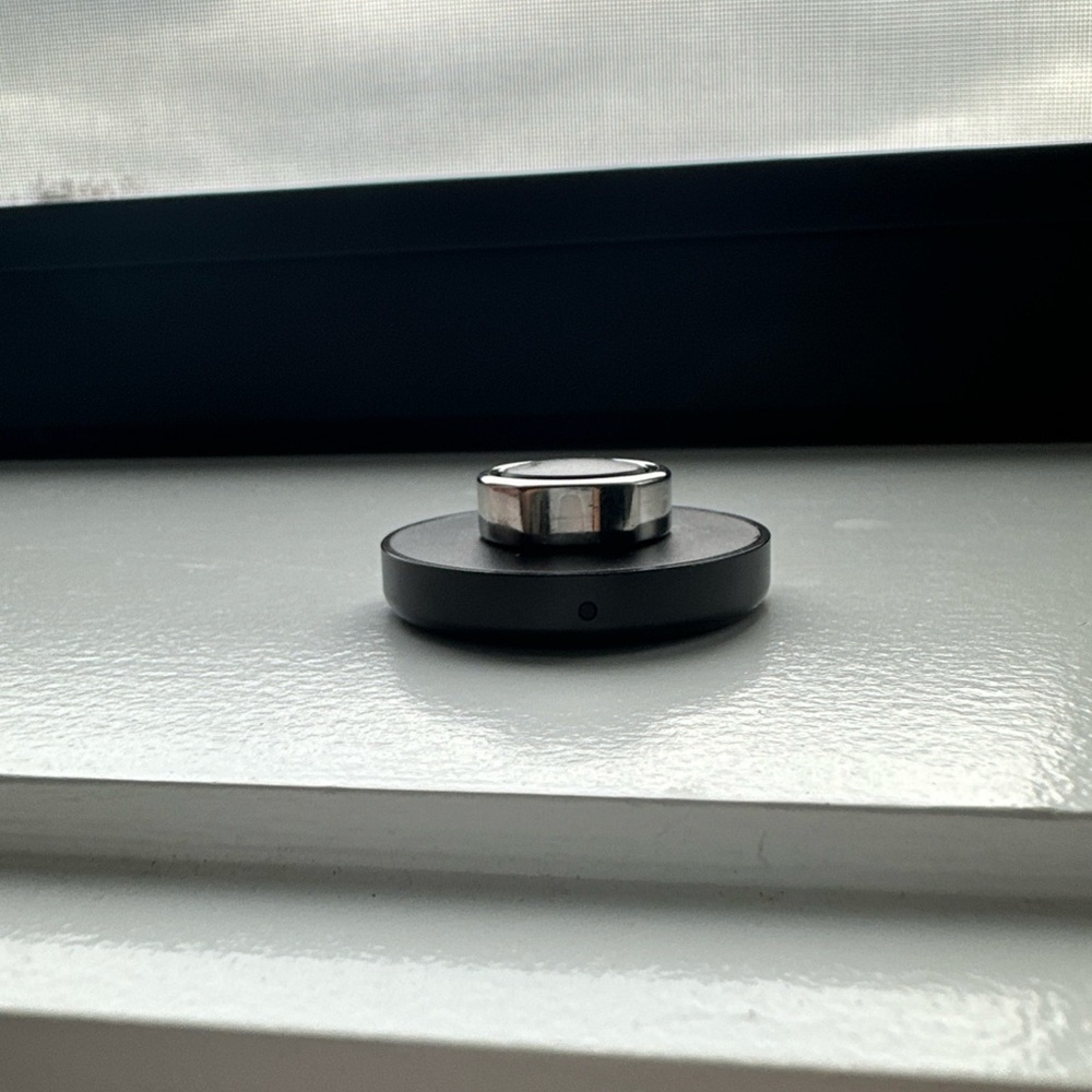 Oura Silver Ring on Black Charger